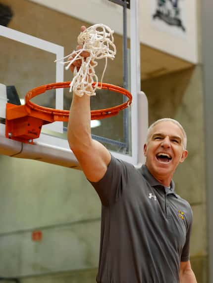 McKinney head coach Wes Watson waves the net after they defeated Arlington Martin in the...
