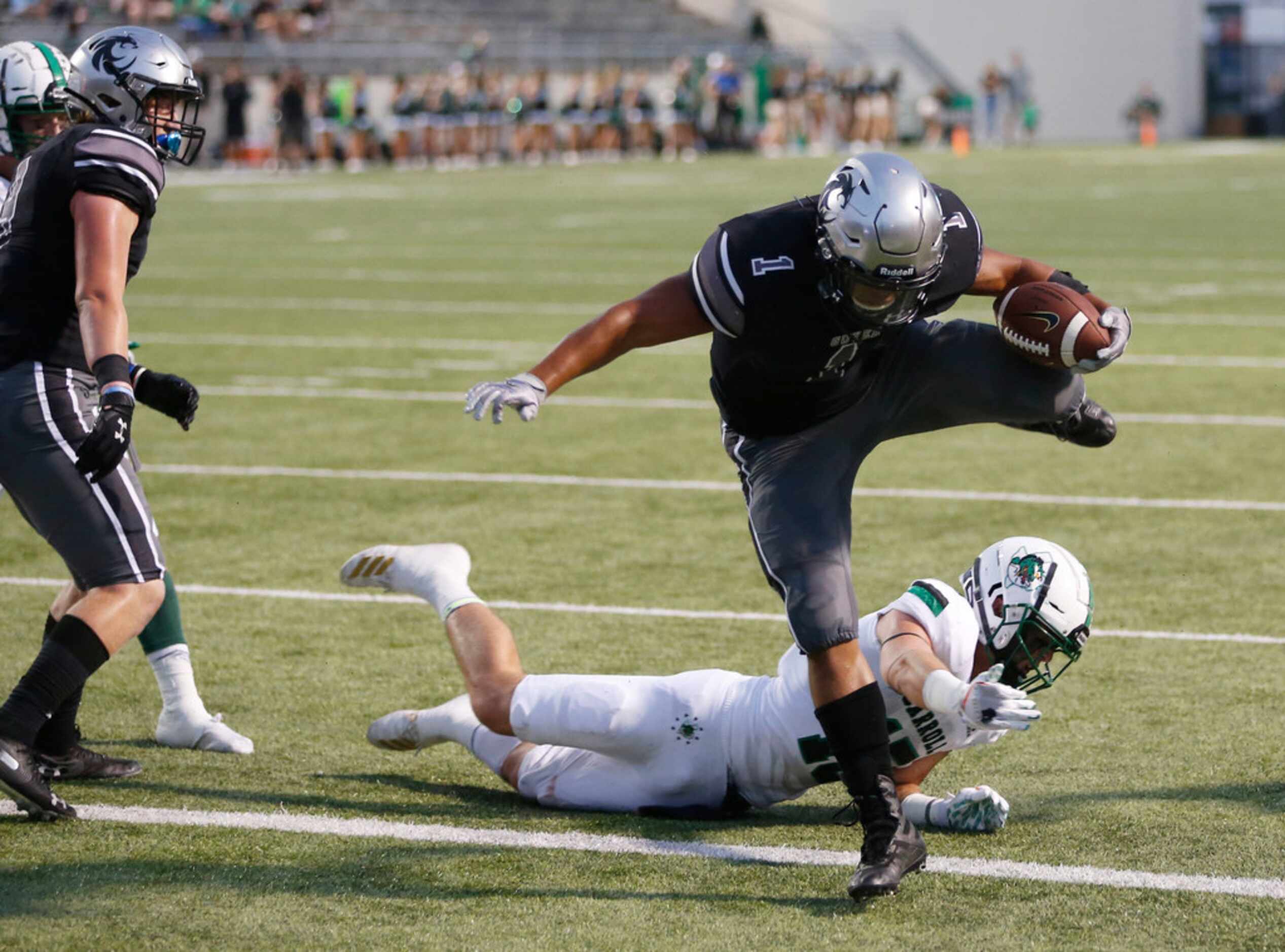 Denton Guyer's Kaedric Cobbs (1) scores on the two point conversion after getting past...