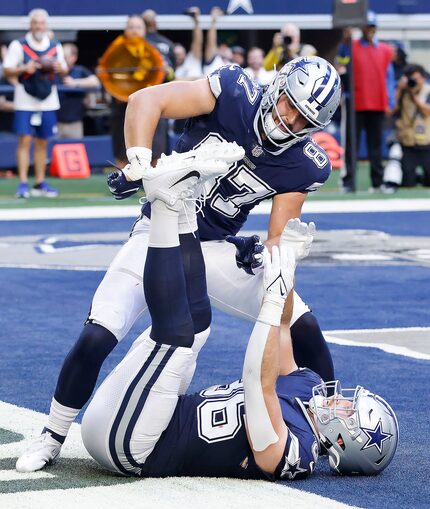 Dallas Cowboys tight end Jake Ferguson (87) mimics wrapping up Dalton Schultz’s (86) feet...