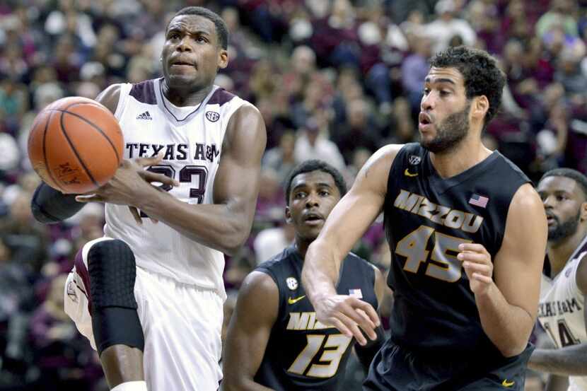 Texas A&M's Danuel House (23) has the ball knocked out of his hands by Missouri forward...