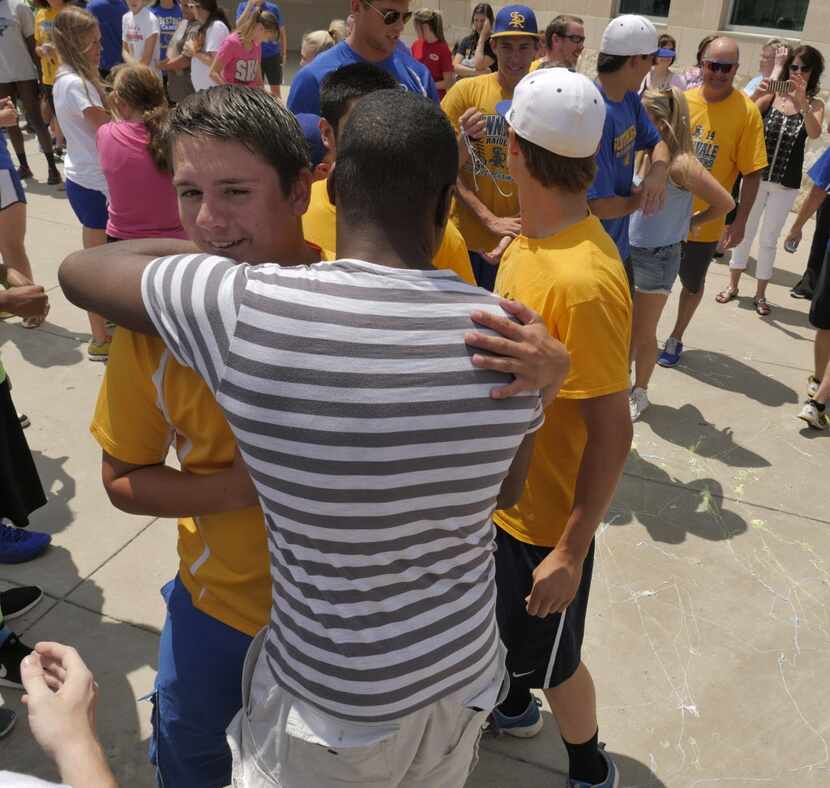 Sunnyvale High School boys baseball team member Kurt Fitzgerald receives a hug from...