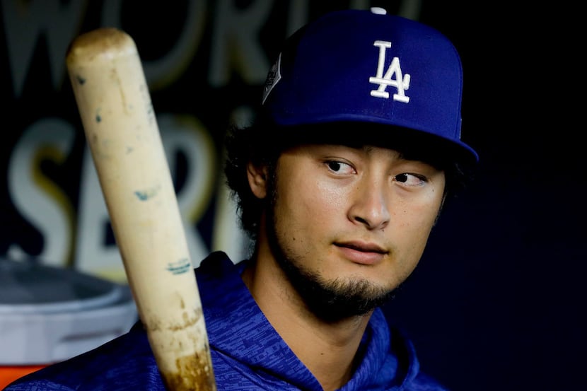Los Angeles Dodgers starting pitcher Yu Darvish, of Japan, watches batting practice before...