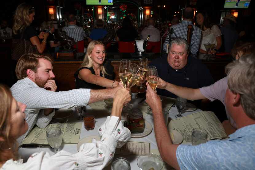 Kyle and Gracie Fowler clink glasses with Robert Fulford and the rest of the Bolner family...