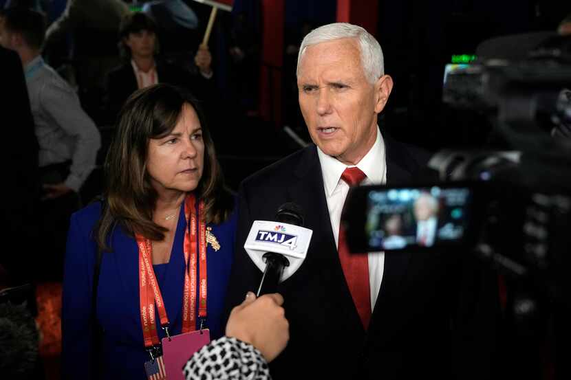 Former Vice President Mike Pence talks to reporters in the spin room after the first...