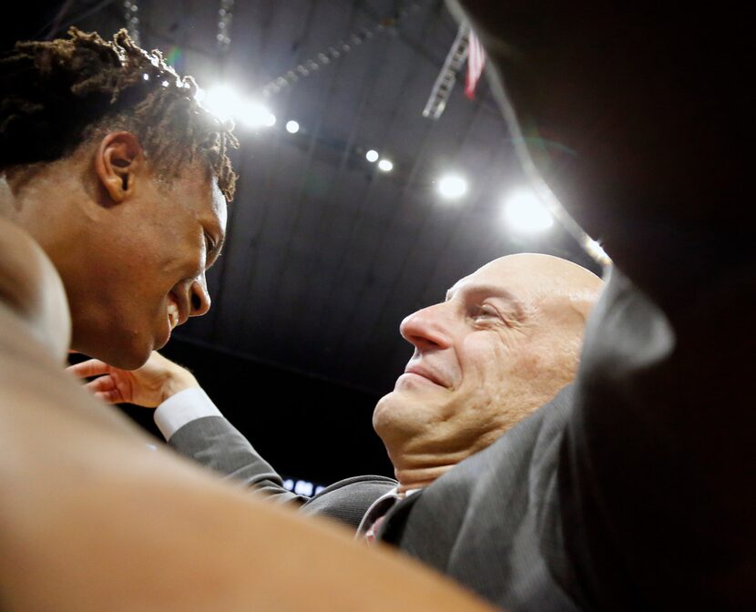 Head coach Duane Gregory hugs Mansfield Timberview's Trazarien White #23. UIL boys...