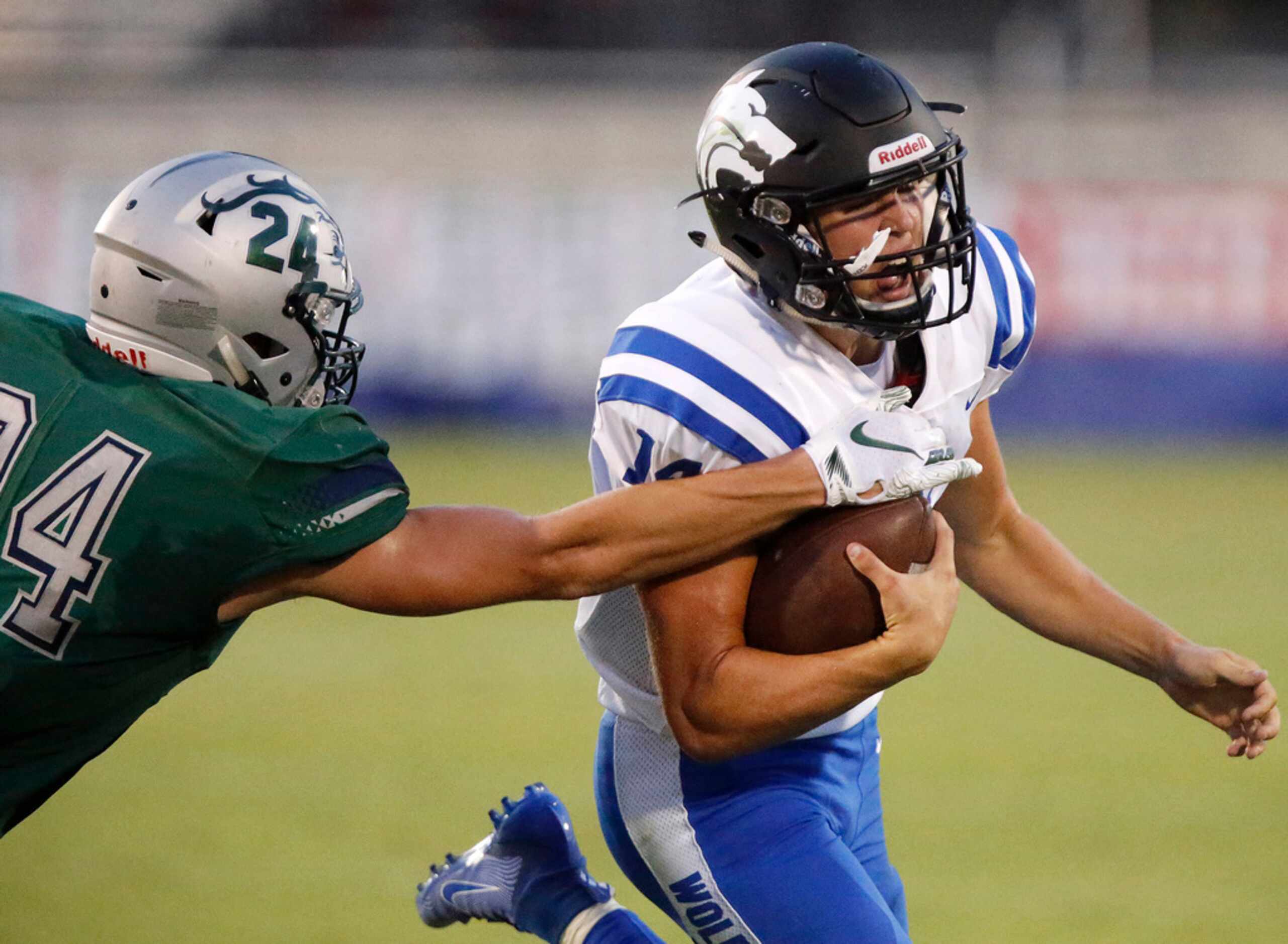Plano West High School quarterback Andrew Picco (14) tries to evade Reedy High School...