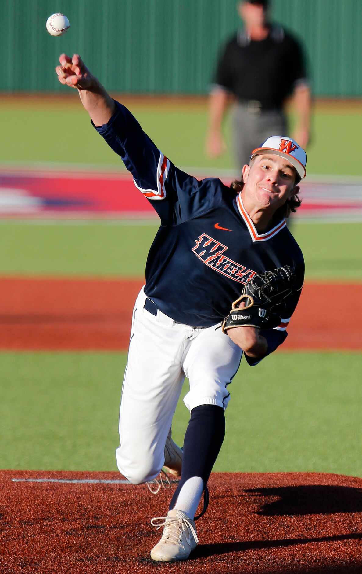 Wakeland High School pitcher Luke Robertson (7) delivers a pitch in the first inning during...