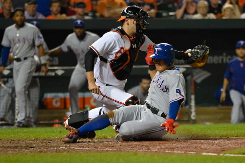 Jul 2, 2015; Baltimore, MD, USA; Texas Rangers right fielder Shin-Soo Choo (17) slides under...