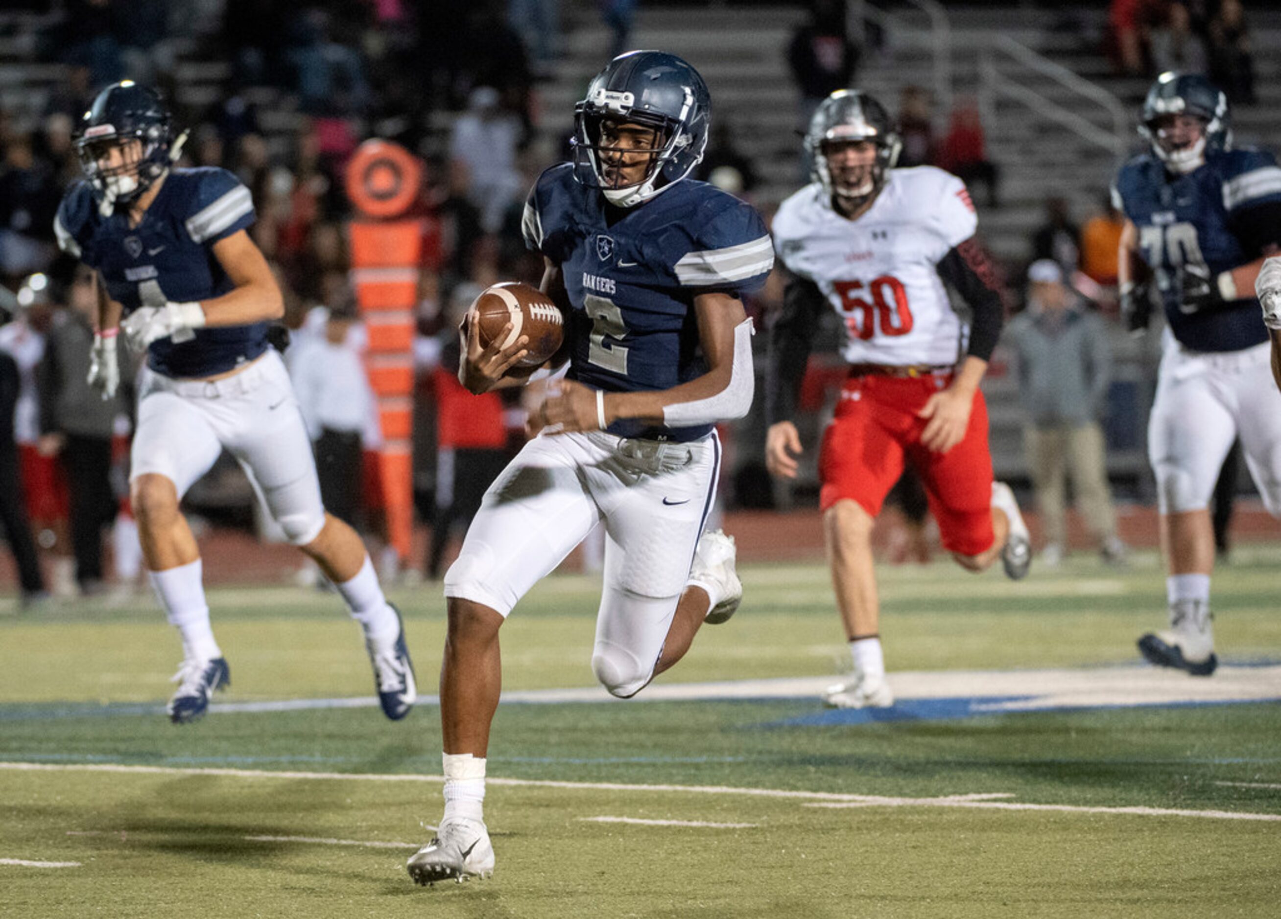 Frisco Lone Star junior quarterback Julian Larry (2) runs for a big gain against Mansfield...