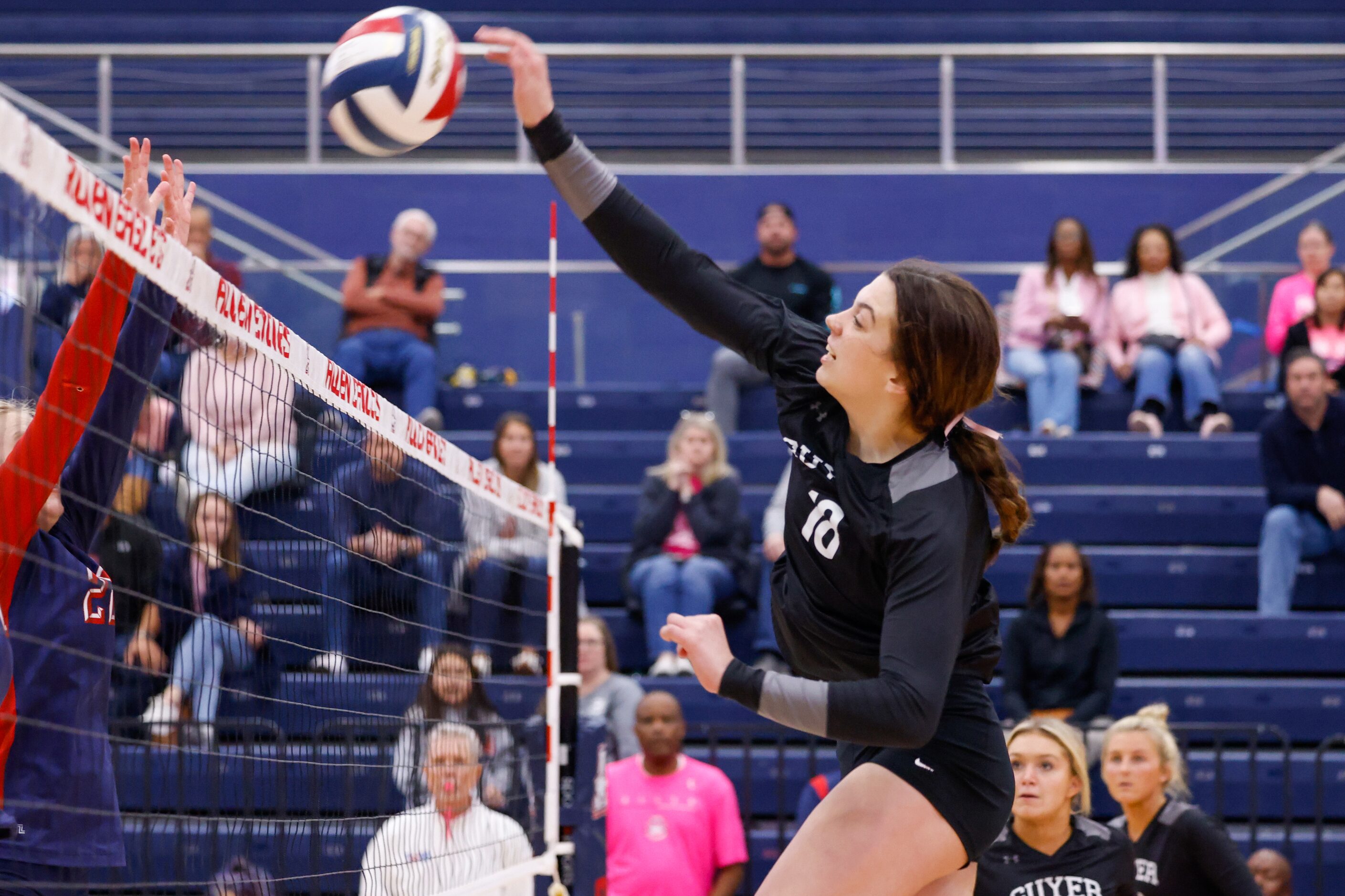 Denton Guyer senior Erika Gustafson (18) spikes the ball for a point against Allen in the...