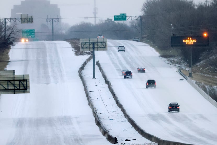 Drivers navigated a sleet-covered Interstate 30 as they entered into Arlington on Feb. 3, 2022.