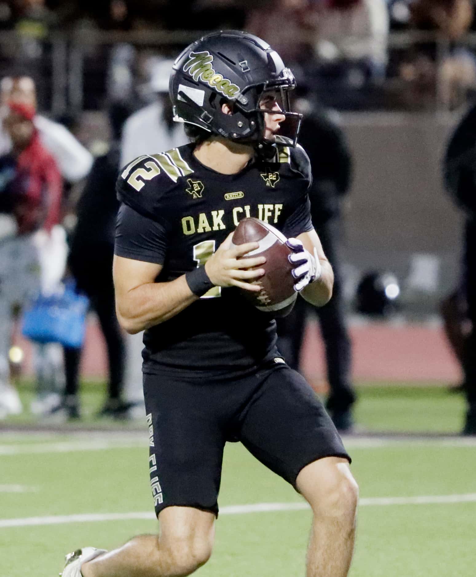 South Oak Cliff High School quarterback Carter Kopecky (12) drops back during the first half...