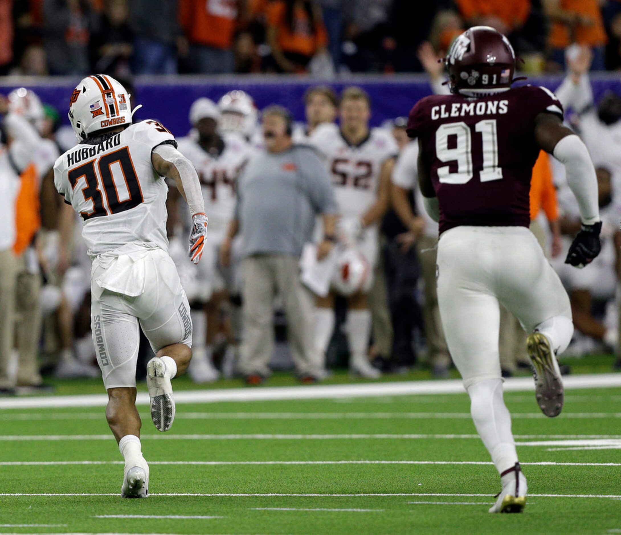 HOUSTON, TEXAS - DECEMBER 27: Chuba Hubbard #30 of the Oklahoma State Cowboys runs with the...