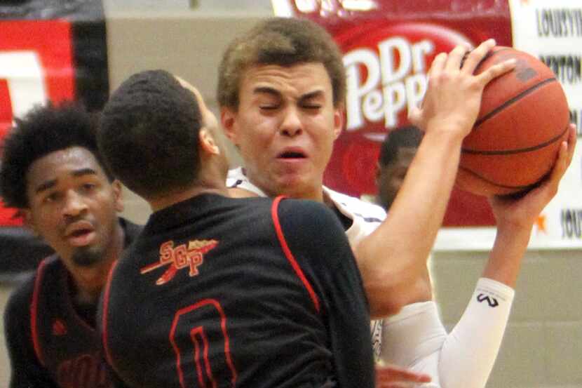 Plano West junior forward DJ Hogg (1) grimaces after colliding with South Grand Prairie...