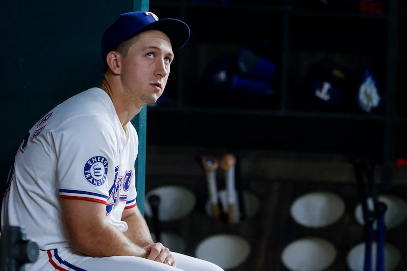 Texas Rangers outfielder Wyatt Langford (right) remains int eh dug out during a baseball...