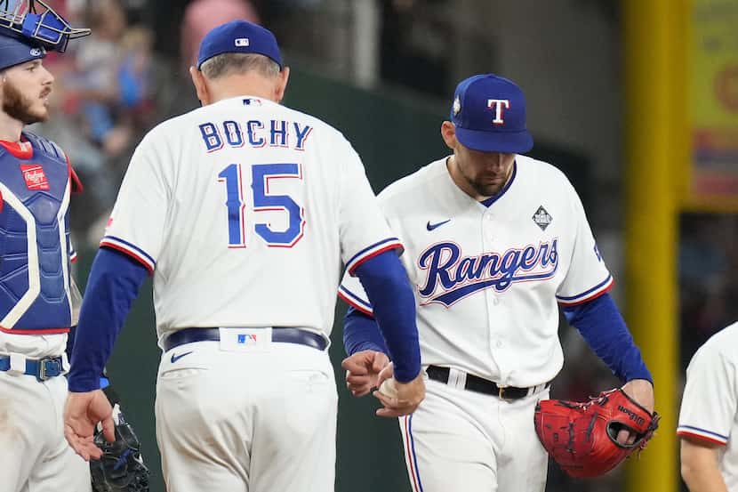 Texas Rangers manager Bruce Bochy (15) takes the ball from starting pitcher Nathan Eovaldi...