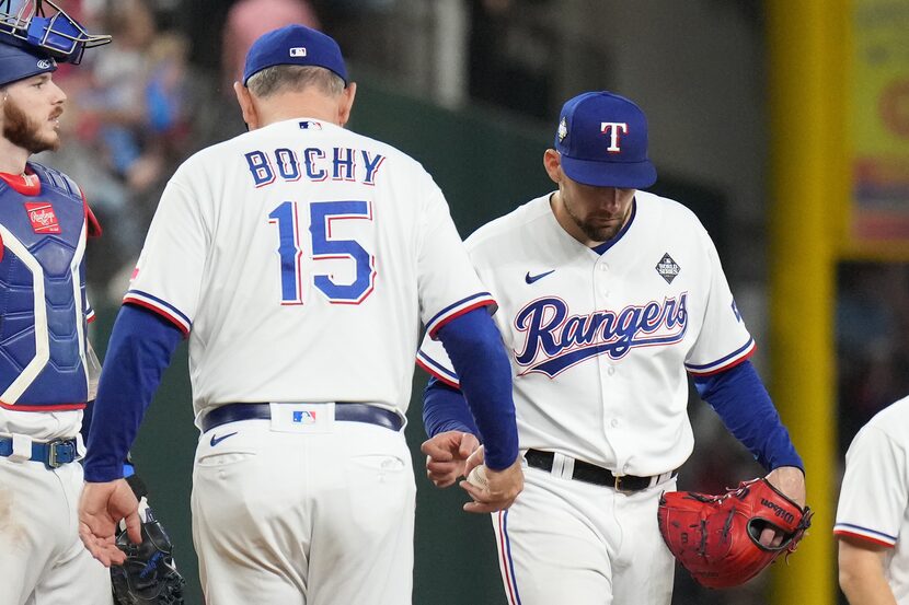 Texas Rangers manager Bruce Bochy (15) takes the ball from starting pitcher Nathan Eovaldi...