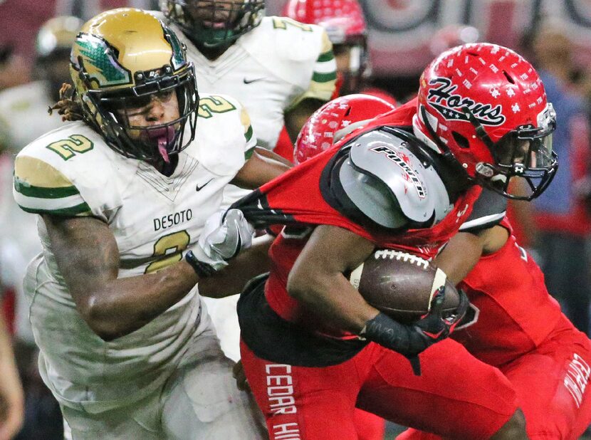 DeSoto's Laviska Shenault Jr. (2) grabs the jersey of Cedar Hill's Jihad Thomas (22) in the...