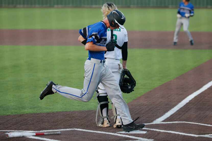 Byron Nelson's Ethan Thomas (23) scores in front of Southlake catcher Matty Werner (3)...
