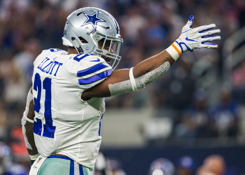 Dallas Cowboys running back Ezekiel Elliott points toward the end zone during the fourth...