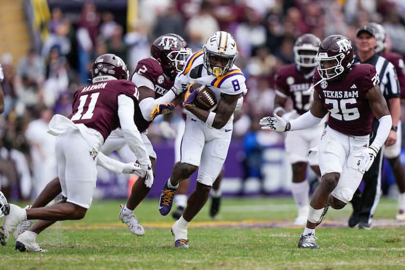 LSU wide receiver Malik Nabers (8) carries between Texas A&M defensive back Jacoby Mathews...
