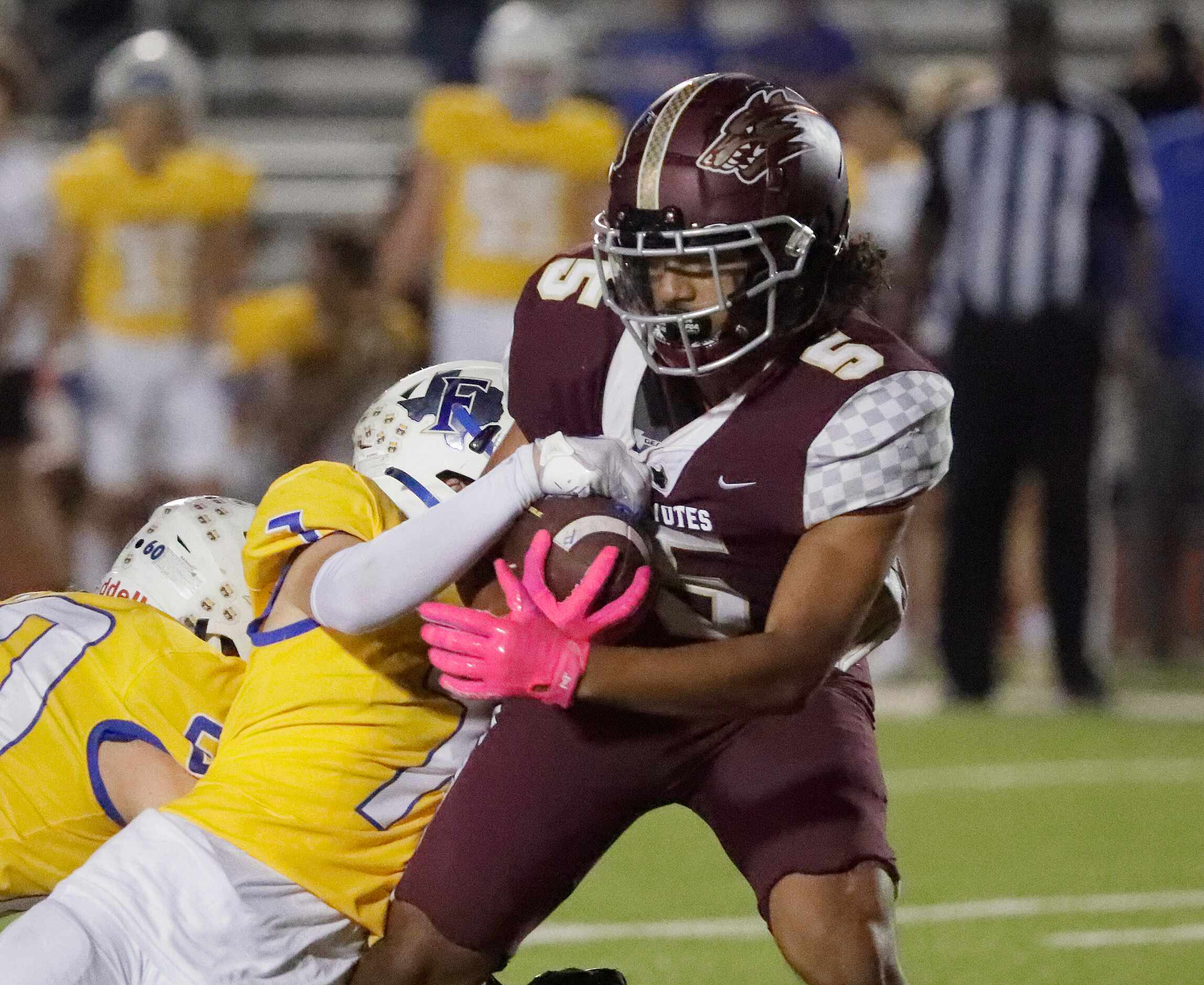 Frisco Heritage High School wide receiver Vincent Hooper (5) is tackled by Frisco High...