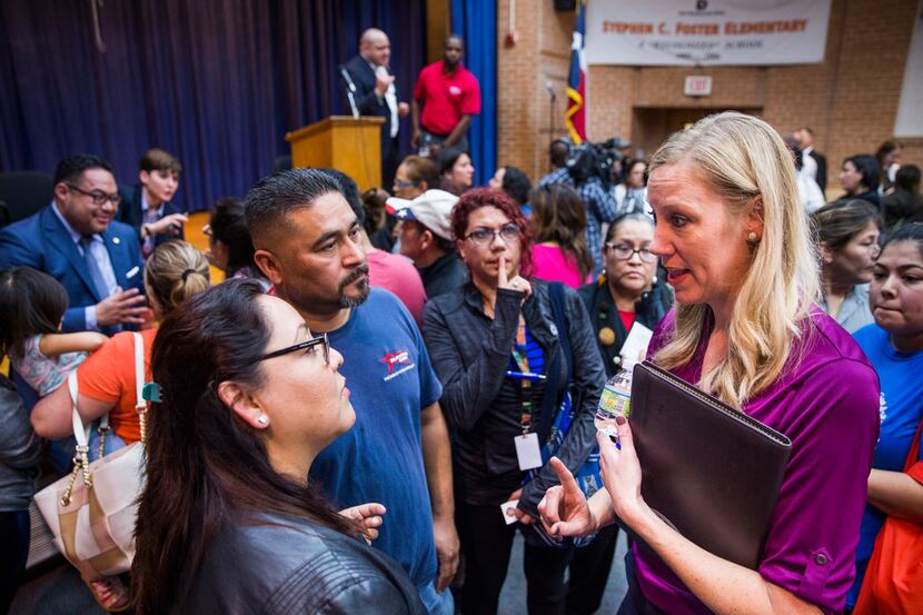 Jennifer Altieri, right, director of public affairs for Atmos Energy, speaks to concerned...