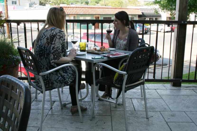 
Noël Crotty (left) and Hannah Moore enjoy drinks on the patio at Times Ten Cellars in...