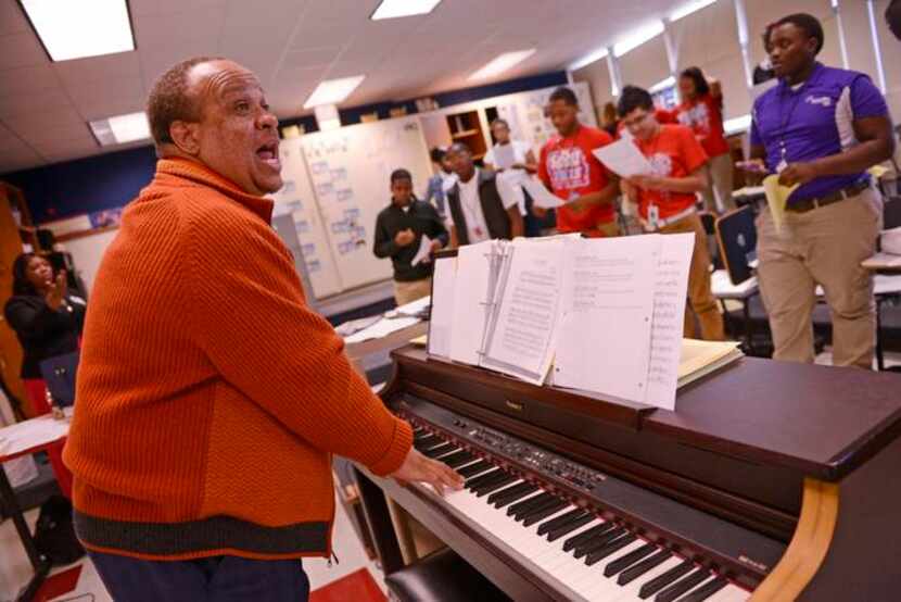 
Choir director Demetrius Ethley leads students during a choir practice at David W. Carter...