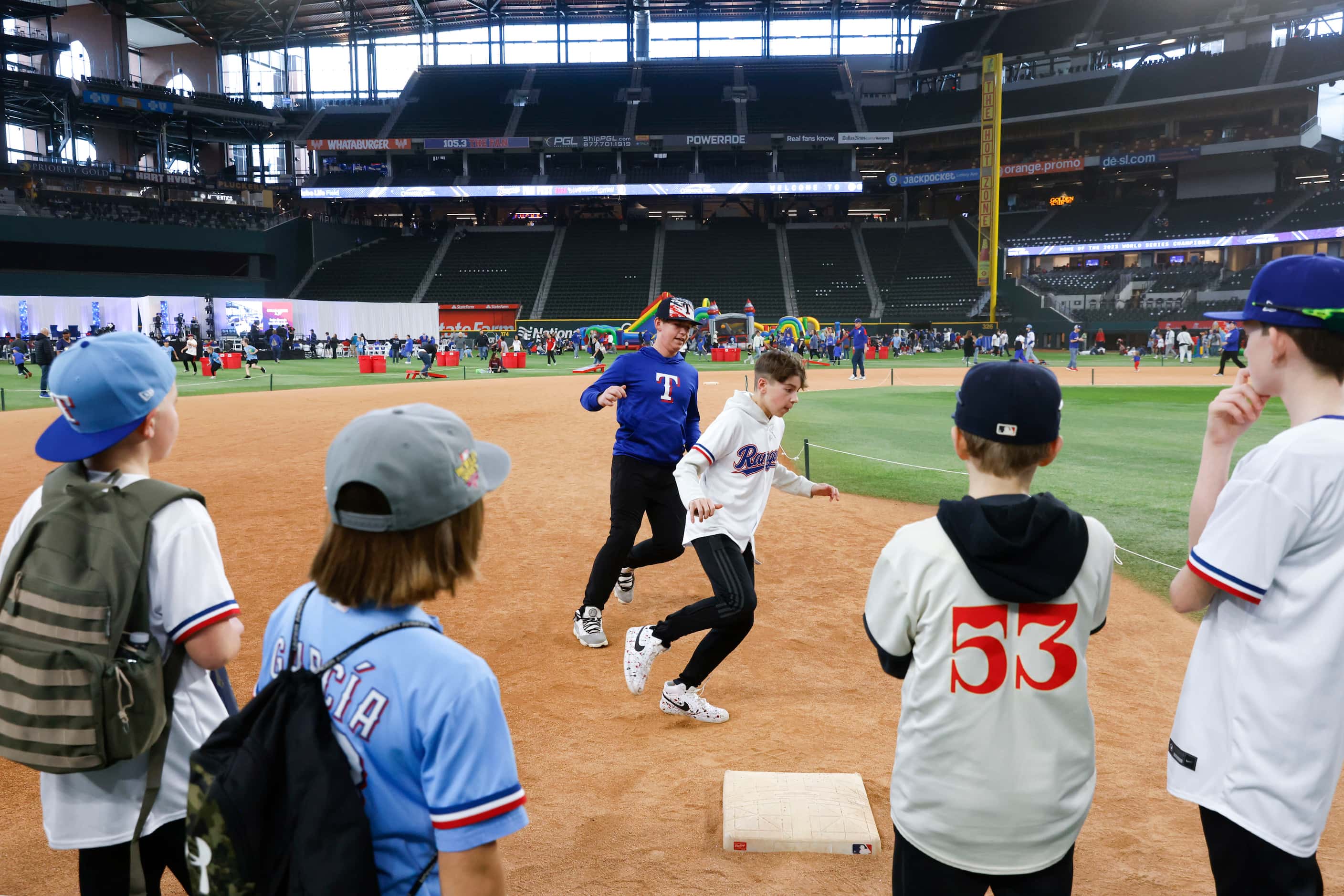 Kids take part in base running during Texas Rangers Fan Fest on, Saturday, Jan. 27, 2024, at...