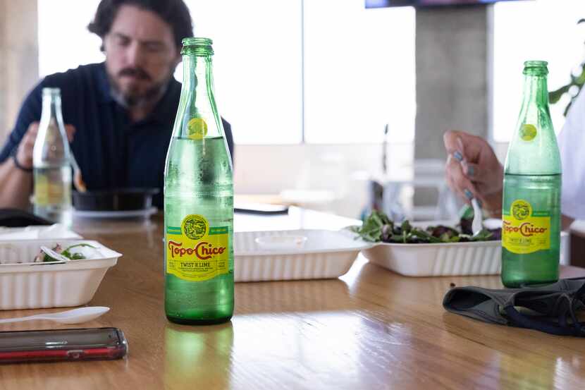 Employees enjoy Topo Chico during lunch on Sept. 2 at the Camelot office in Dallas.