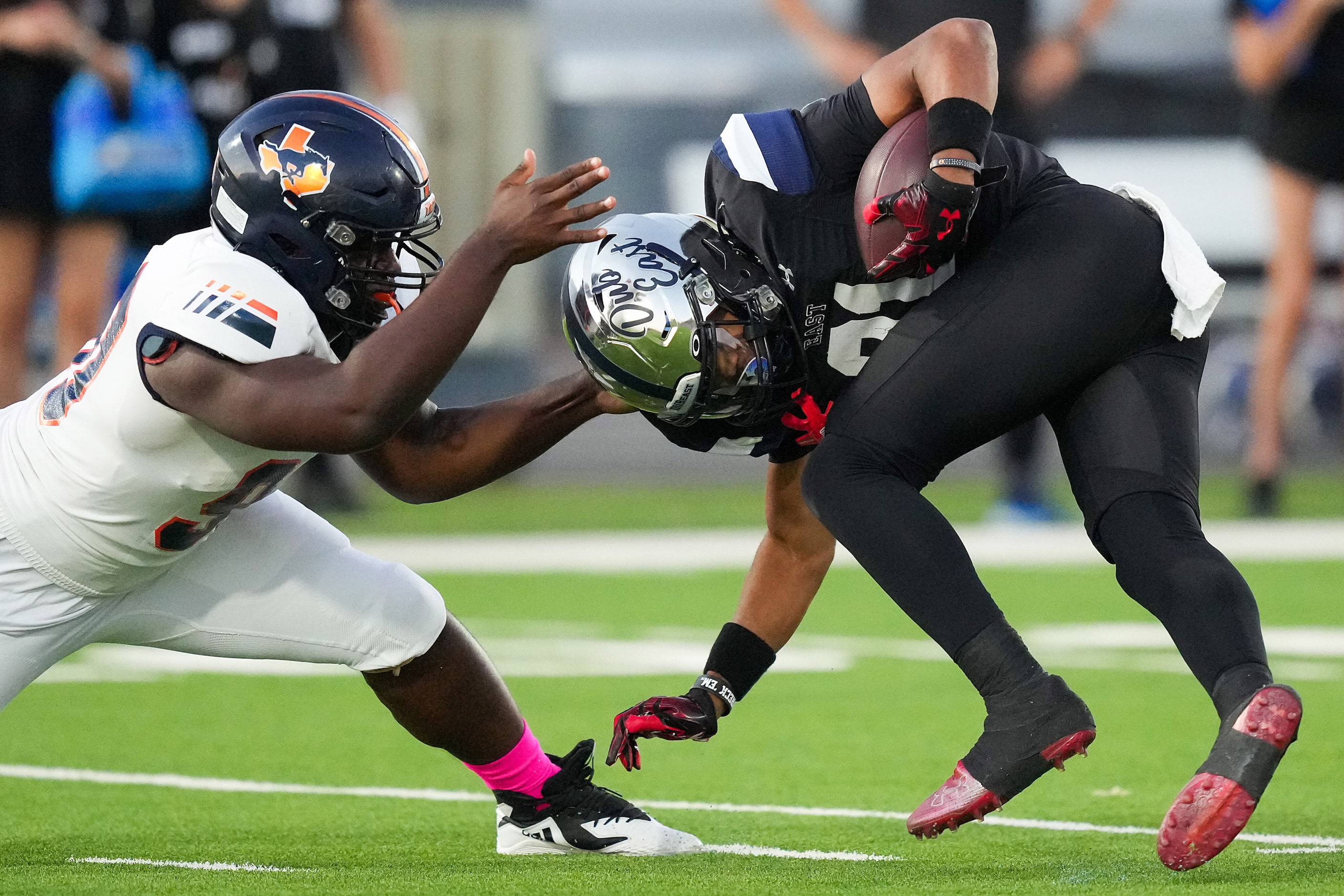 Wylie East running back Michael Henderson III (21) is brought down by Sachse  defensive...