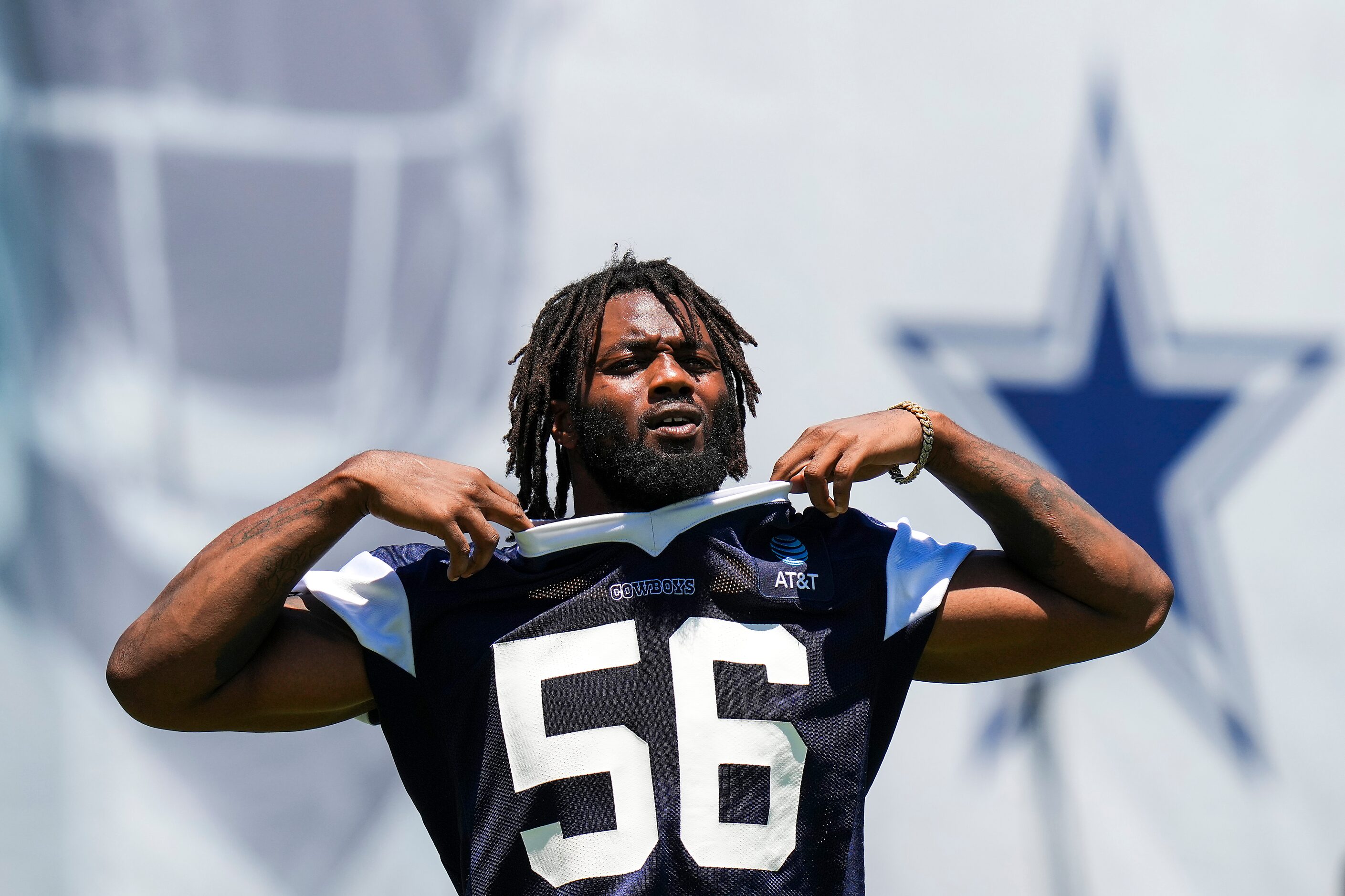 Dallas Cowboys defensive end Dante Fowler Jr. (56) pulls off his jersey after a training...