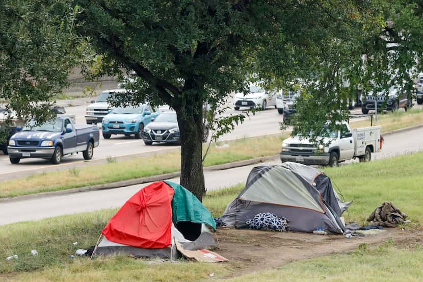 Tents served as makeshift housing against the rain Wednesday alongside Interstate 30 near...