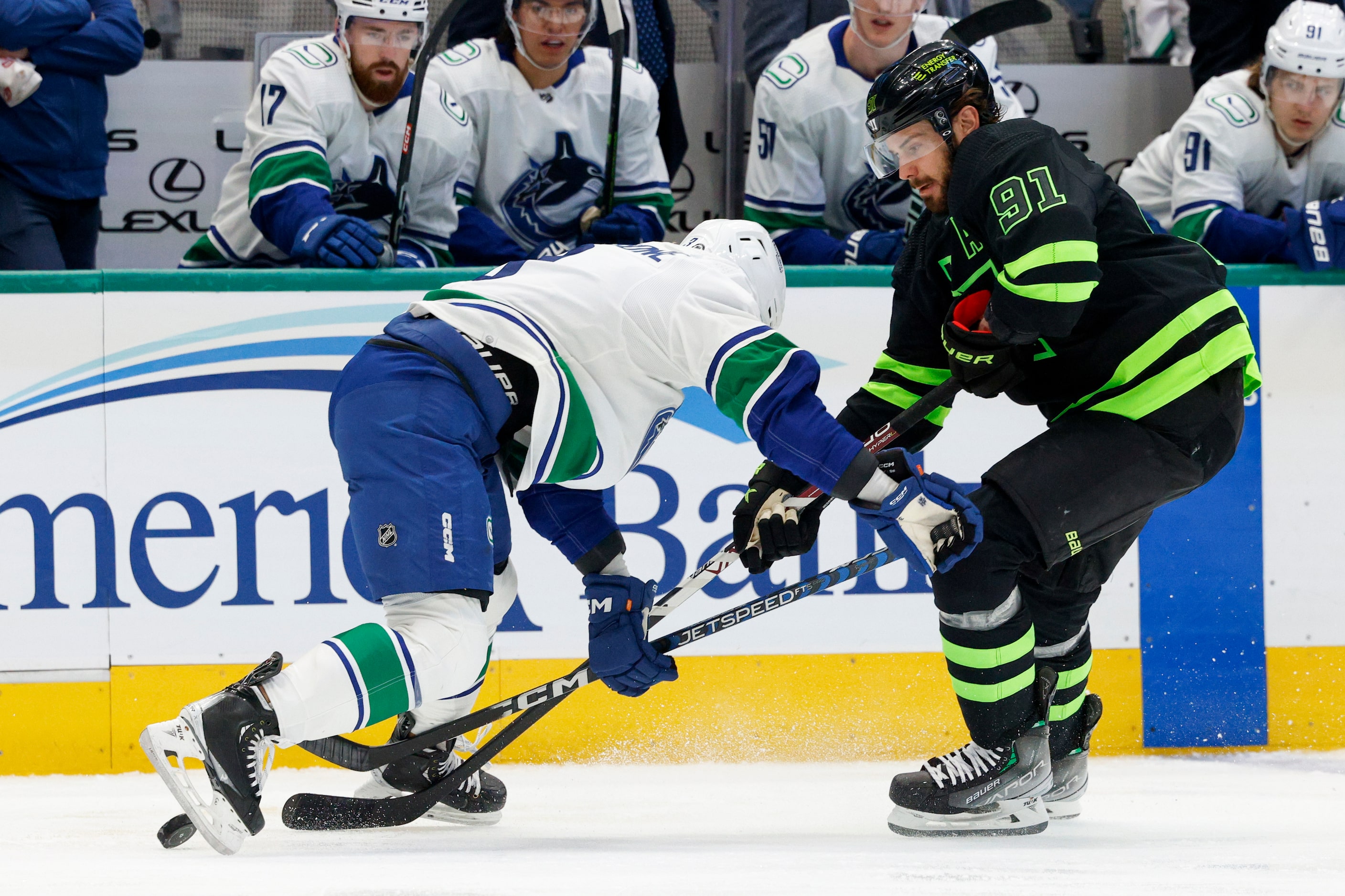 Vancouver Canucks defenseman Jack Rathbone (3) defends against Dallas Stars center Tyler...