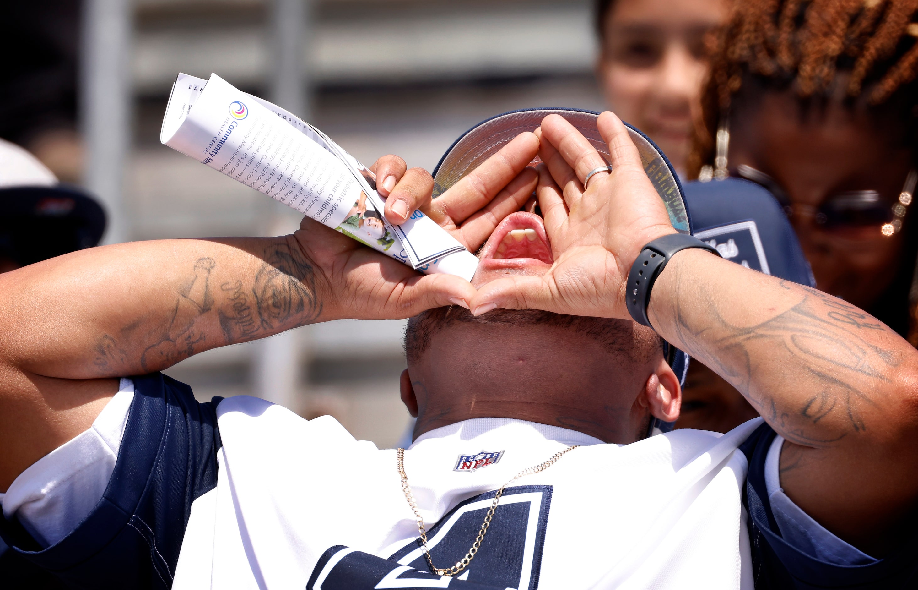 A Dallas Cowboys fans leads cheers in the stands as the team held training camp practice in...