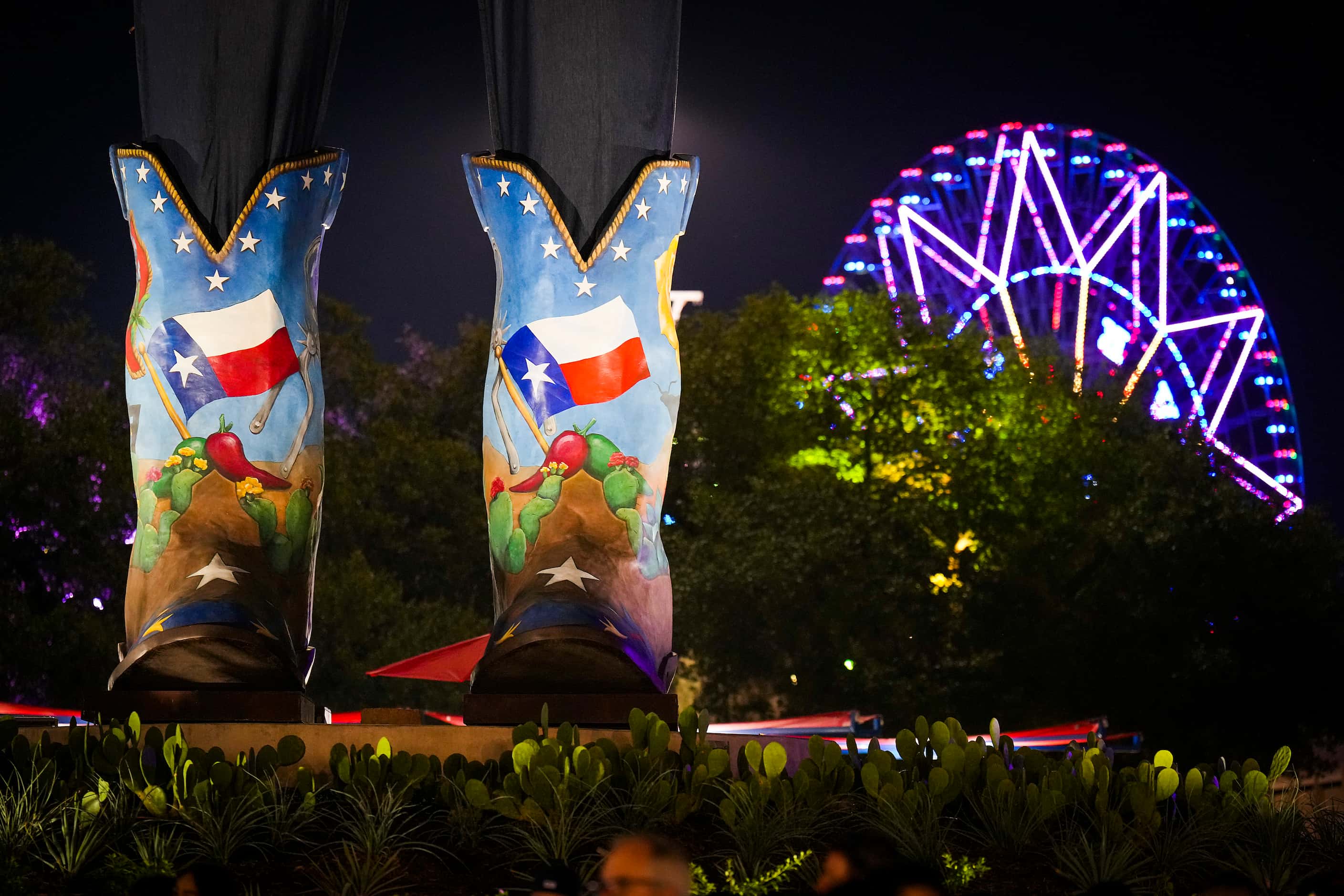 The Texas Star is seen behind the size 96 Lucchese boots of Big Tex on opening night at the...