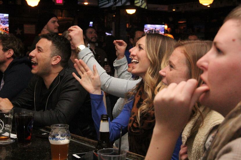 Football fans cheer during a Super Bowl 50 watch party at Henderson Tap House on February 7,...