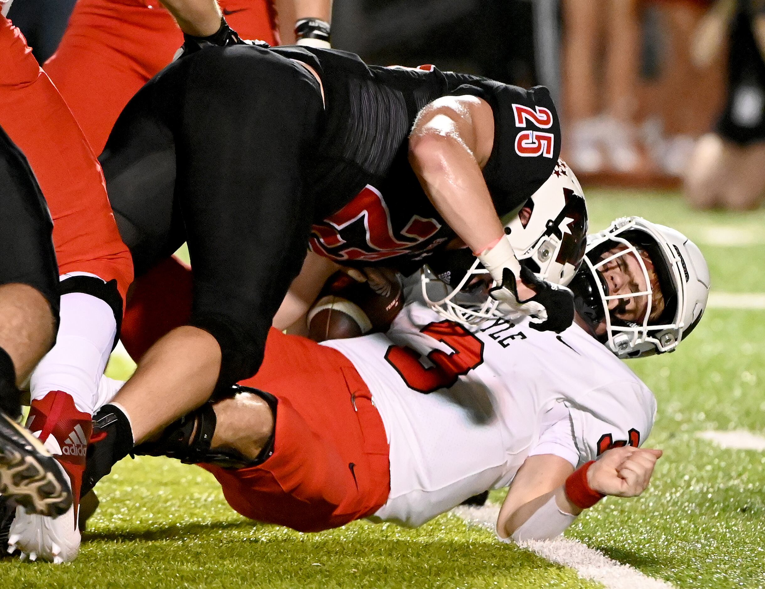 Argyle quarterback Jacob Robinson (3) is sacked by Melissa's Kale Brakebill (25) in the...
