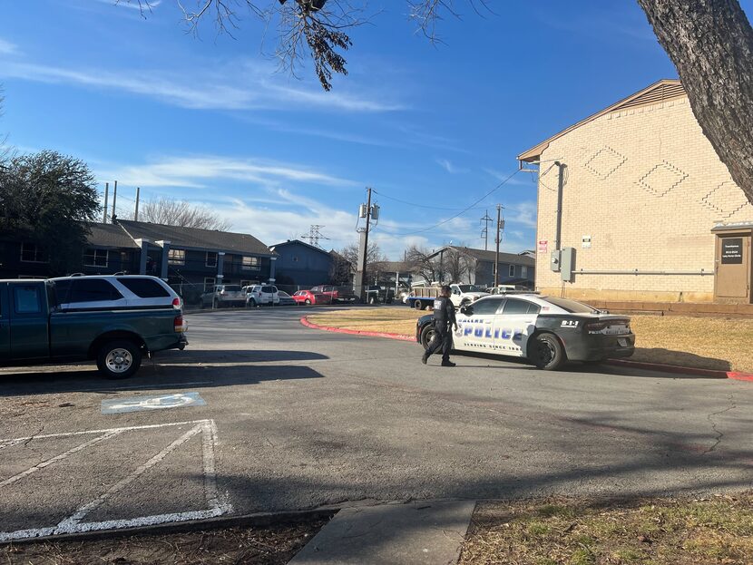 A Dallas police gang detective inspected a parking lot Friday after five people were shot at...