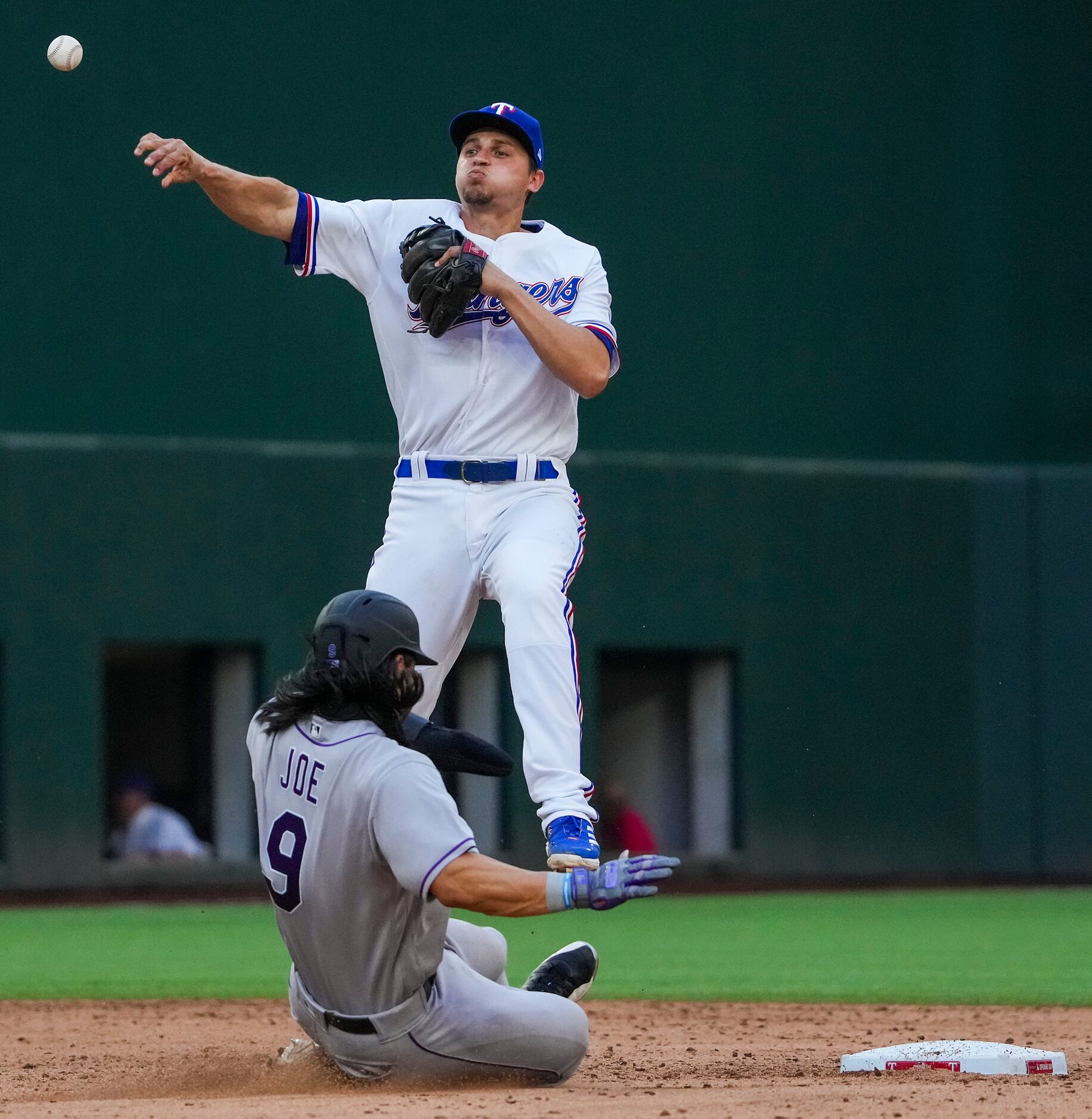 Texas Rangers shortstop Corey Seager commits a throwing error, allowing a run to score and...