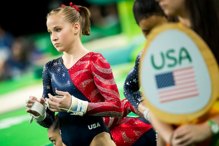 Gymnast Madison Kocian of the USA waits to rotate to the uneven bars during women's...