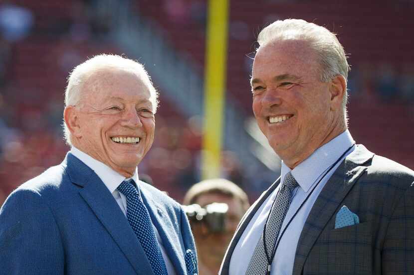 Dallas Cowboys owner Jerry Jones and CEO Stephen Jones watch their team warm before an NFL...