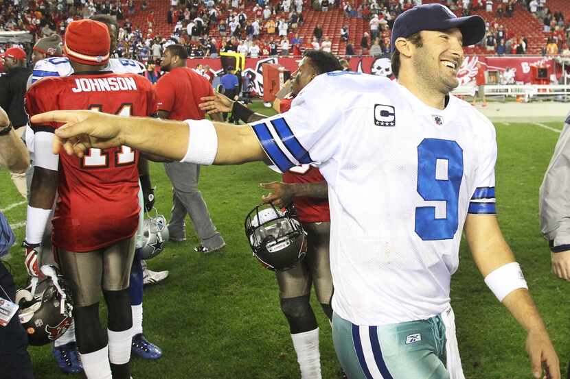 Dallas QB Tony Romo (9) shares a laugh with some Tampa Bay players after the final gun in...