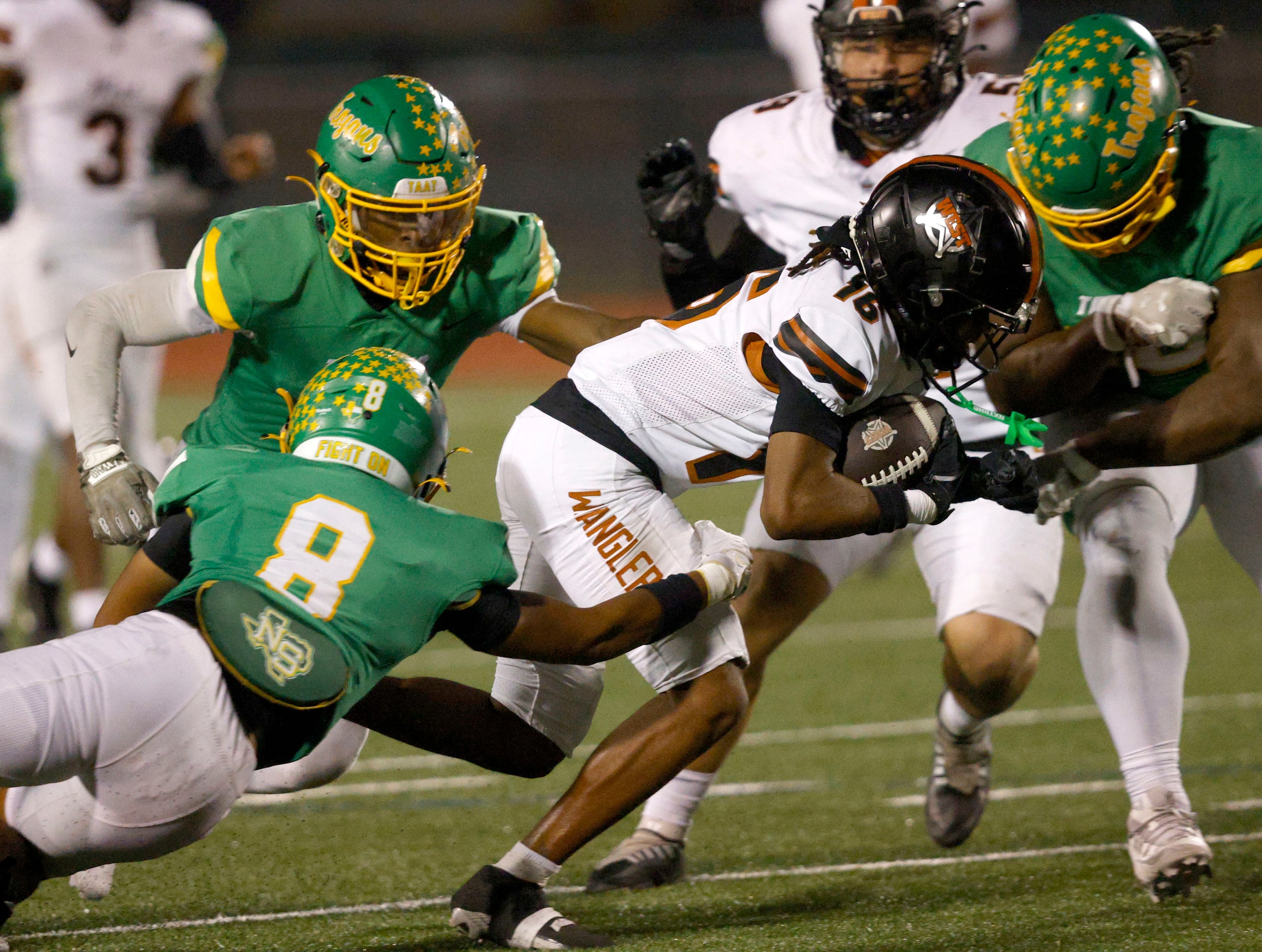 West Mesquite's Darieon Parker (16) carries the ball as Newman Smith defense players try to...