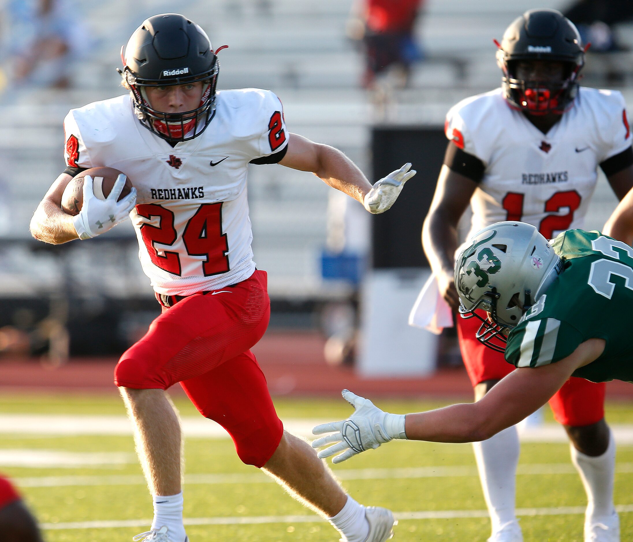 Liberty High running back Jack Bryan (24) tries to avoid Reedy High School School linebacker...