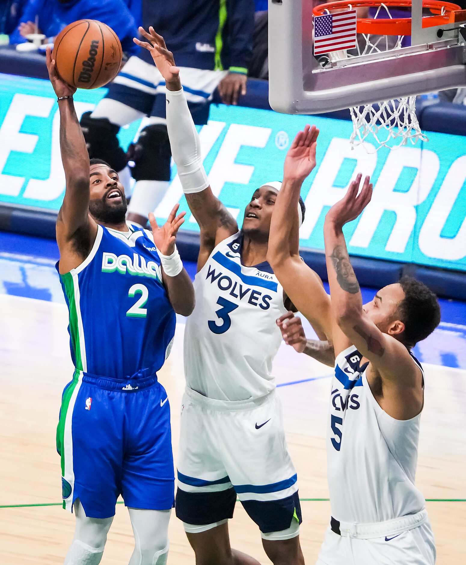 Dallas Mavericks guard Kyrie Irving (2) scores over Minnesota Timberwolves forward Jaden...