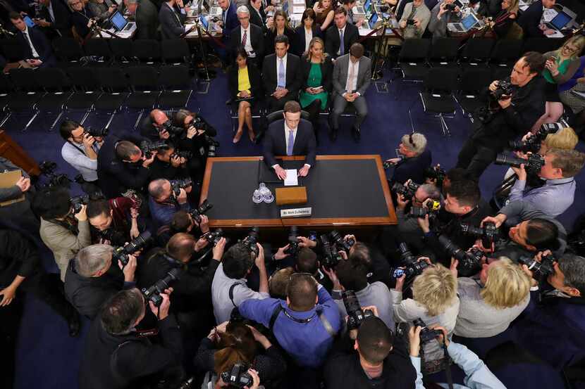 Facebook CEO Mark Zuckerberg was surrounded by news photographers as he arrived Tuesday to...