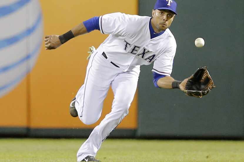 Texas Rangers right fielder Alex Rios catches a fly ball to retire the Seattle Mariners'...