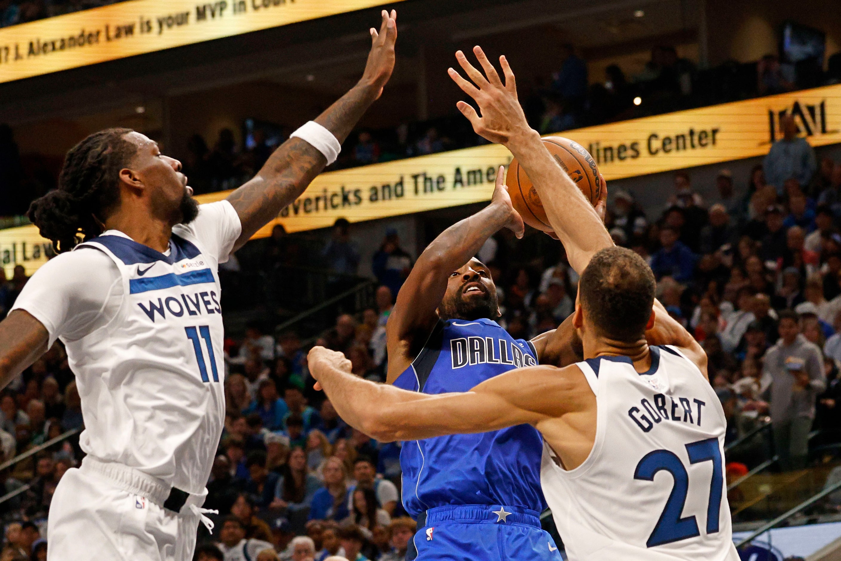 Dallas Mavericks guard Kyrie Irving (11) shoots the ball as Minnesota Timberwolves center...